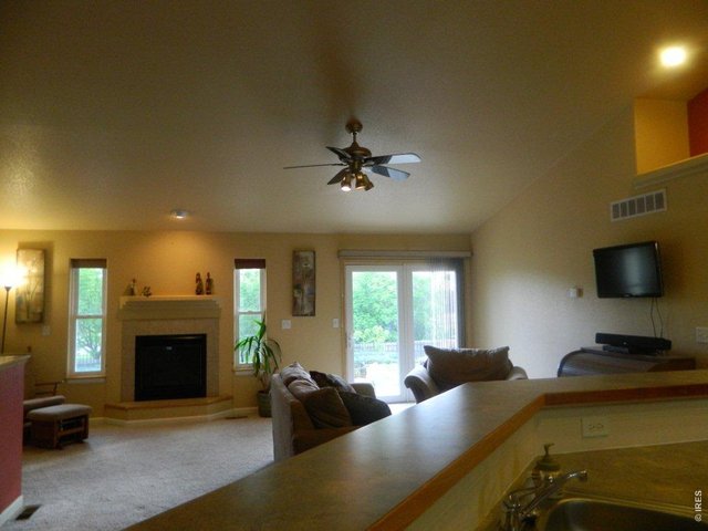 Living room with fireplace and valuted ceilings